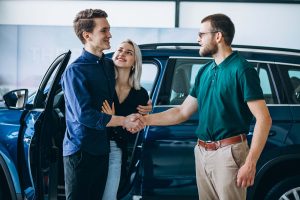 A happy couple receiving their vehicle after repairs