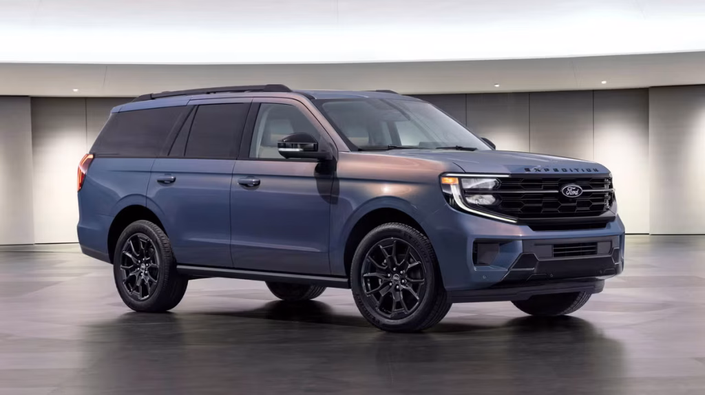 Blue Ford Expedition SUV in a modern showroom, front three-quarter view