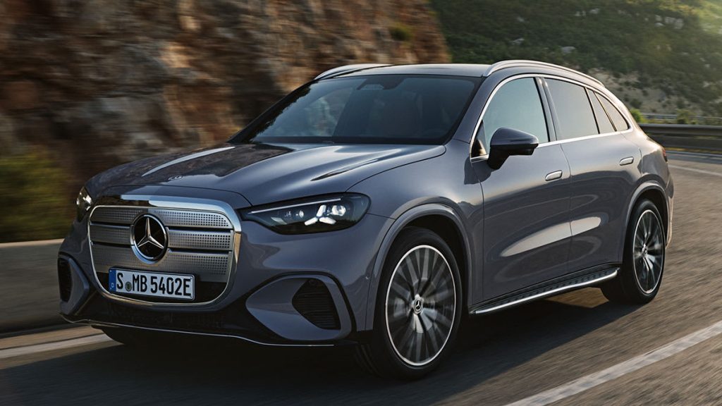 CR-Cars-InlineHero-2027-Mercedes-Benz-GLC-EQ-Electric-f-driving-9-25 | Wagner Certified Collision Front three-quarter view of a silver Mercedes SUV driving on a winding mountain road, with its prominent grille and LED headlights visible.