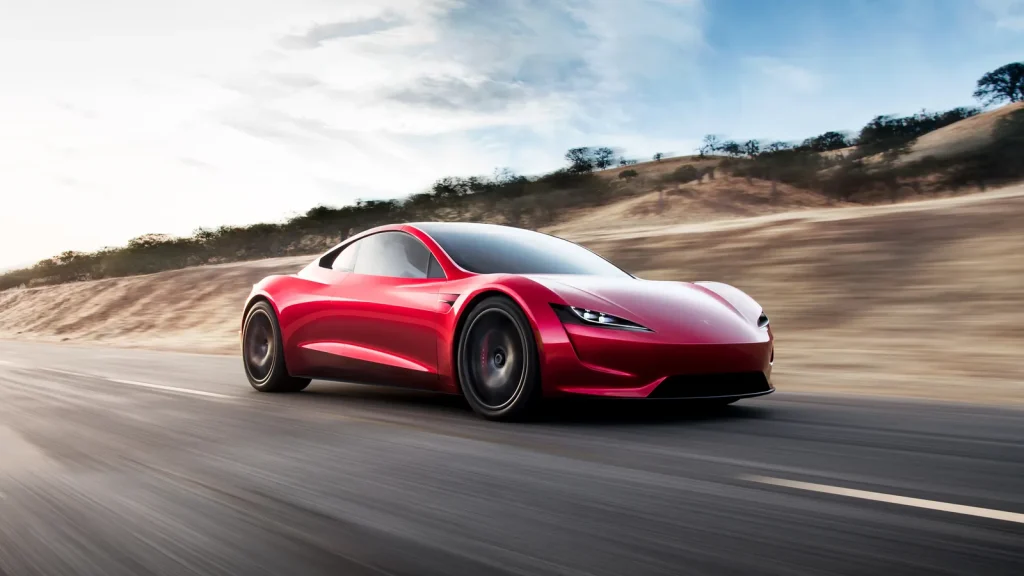 Roadster_Hero | Wagner Certified Collision Red sports car speeding on an open highway with motion blur and desert landscape in the background.