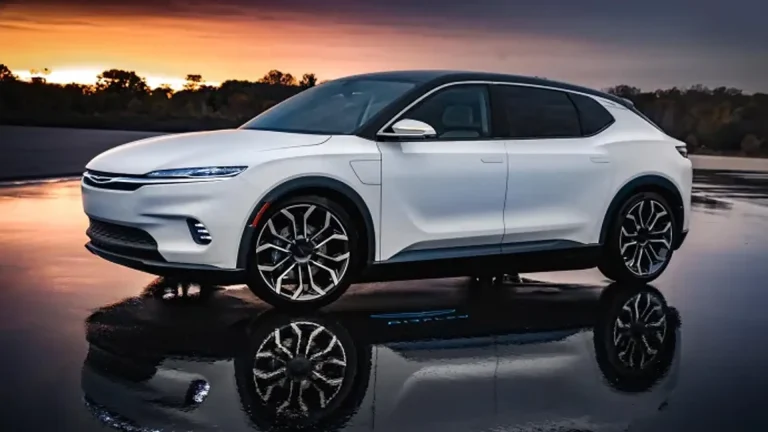White electric SUV parked on a reflective wet surface at sunset, with trees in the background contrasts of orange and blue sky.